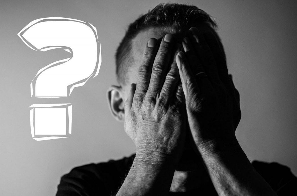 Image of a man covering his face representing a new supervisor, leader, boss, manager mistake for factors to avoid as a new supervisor section. Tips for a new supervisor.