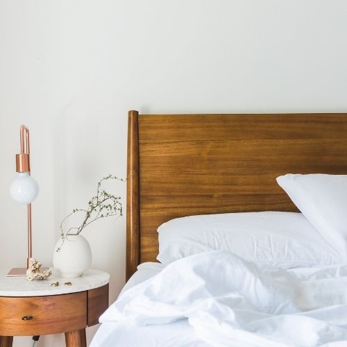 Image of a bedroom with a comfortable-looking mattress.