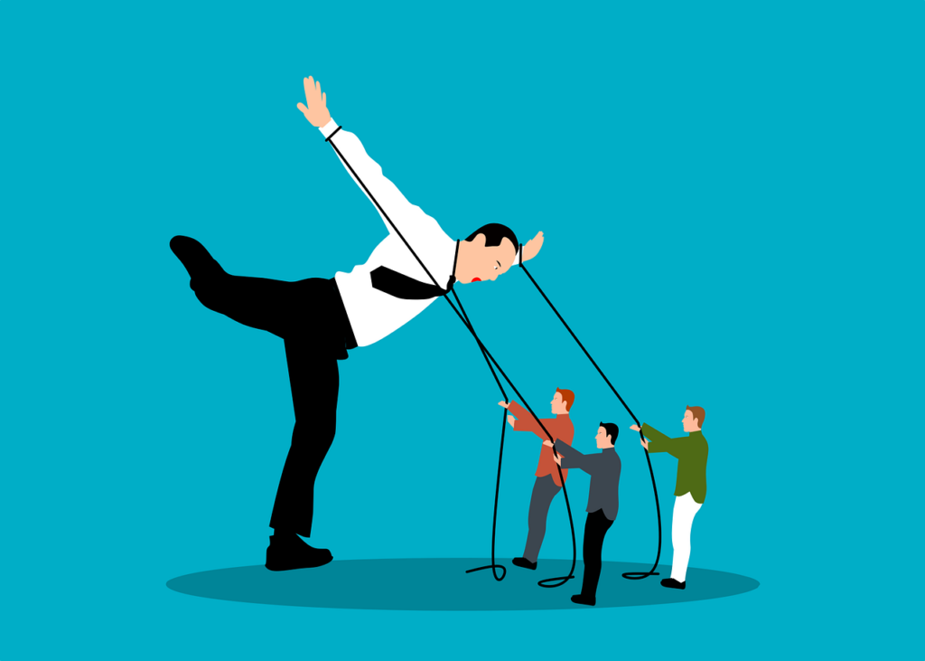A leader ruling with an iron fist being pulled down by people.